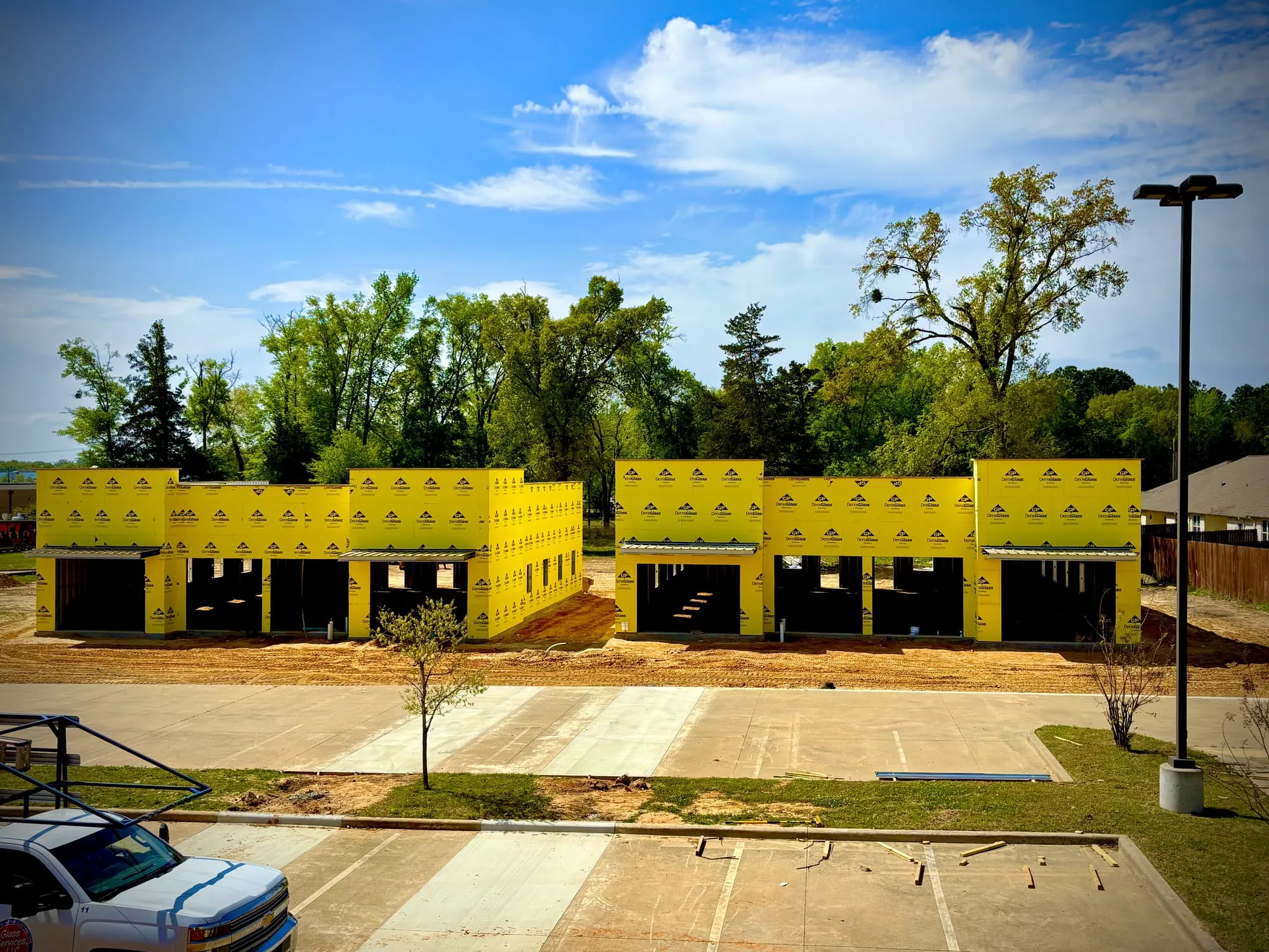 Full view of a commercial retail strip framed and sheathed, ready for finishes