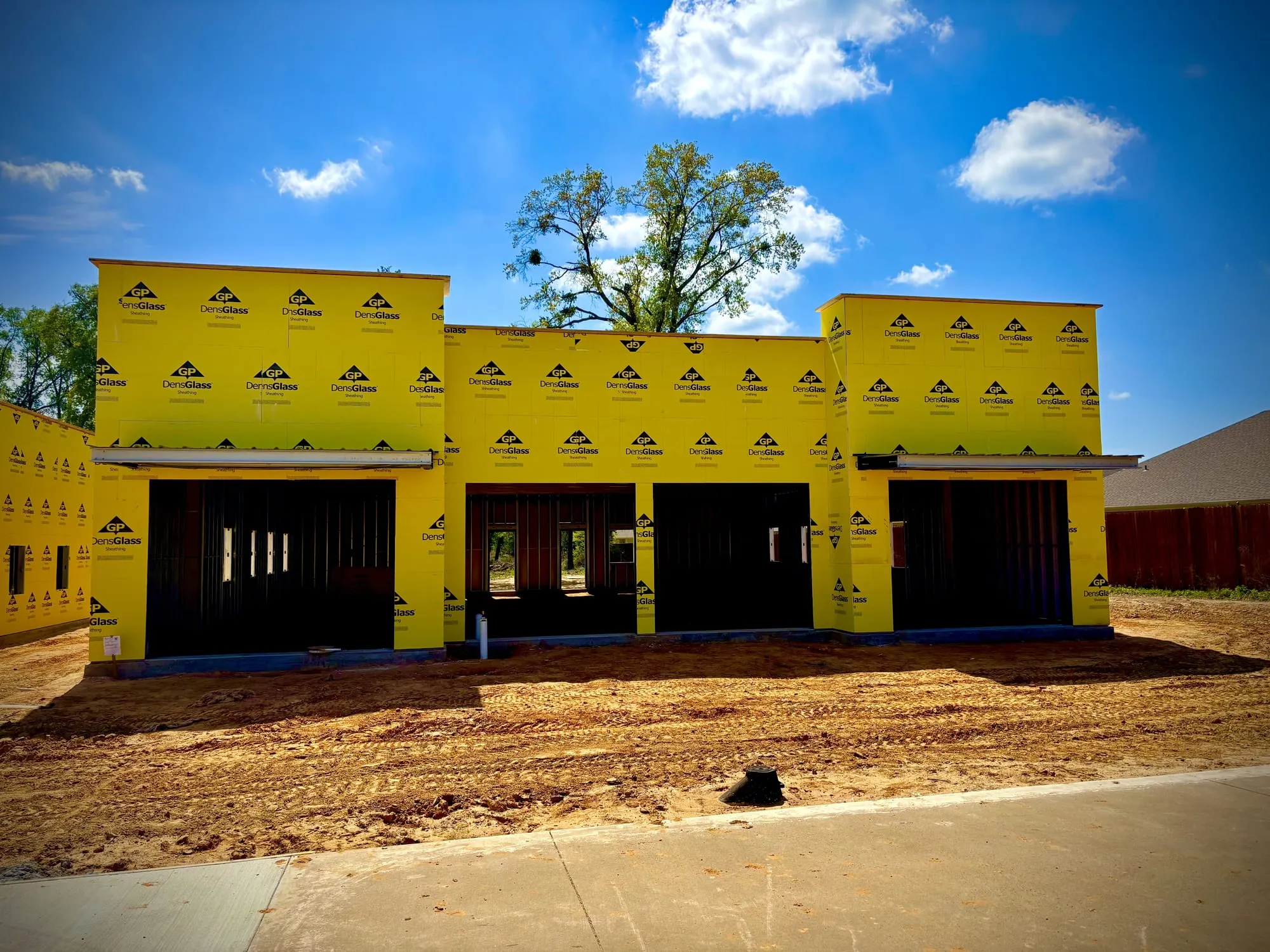 Storefront openings framed in cold-formed metal with exterior sheathing installed
