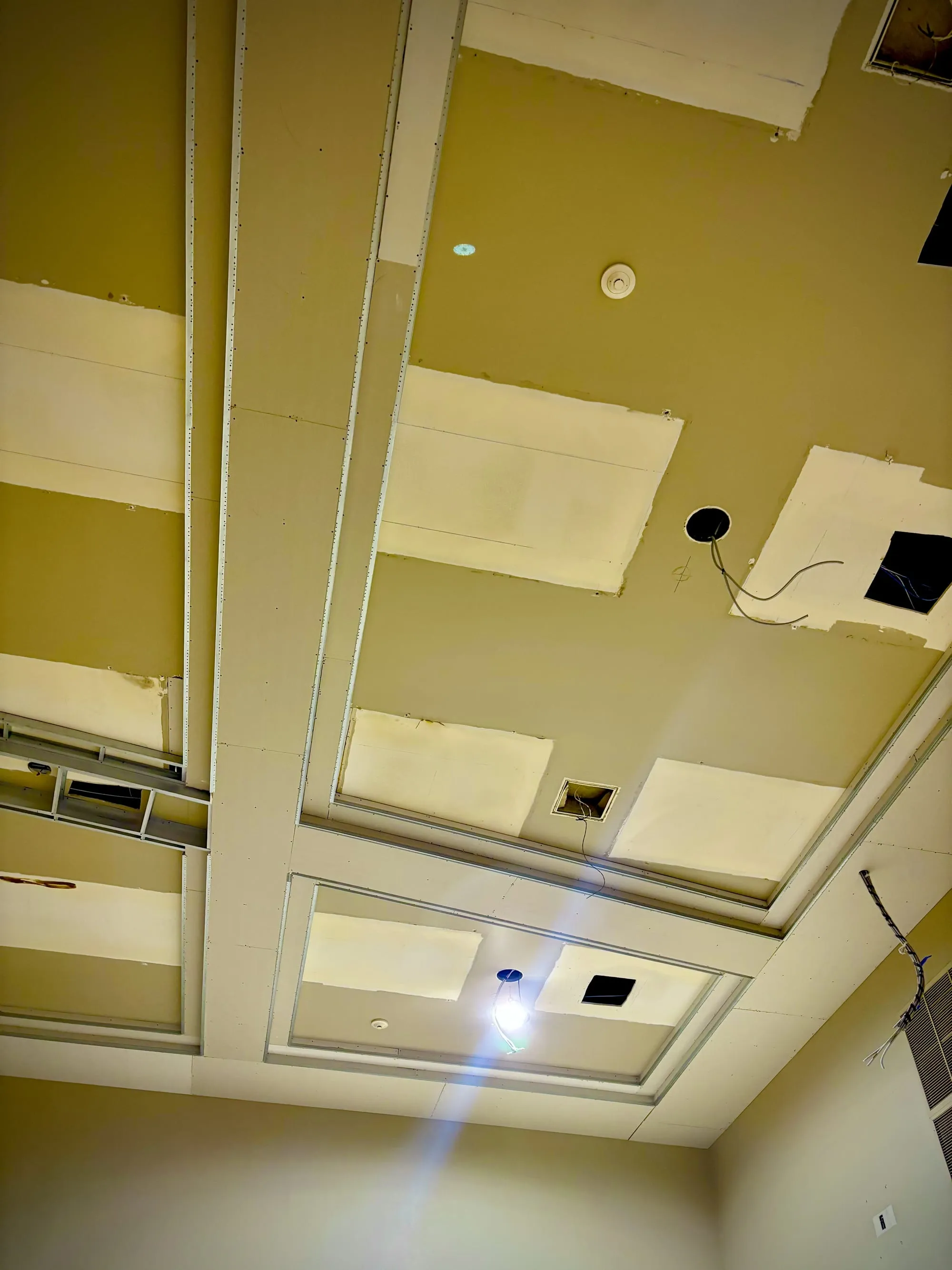 Coffered drywall ceiling detail during a commercial finish-out