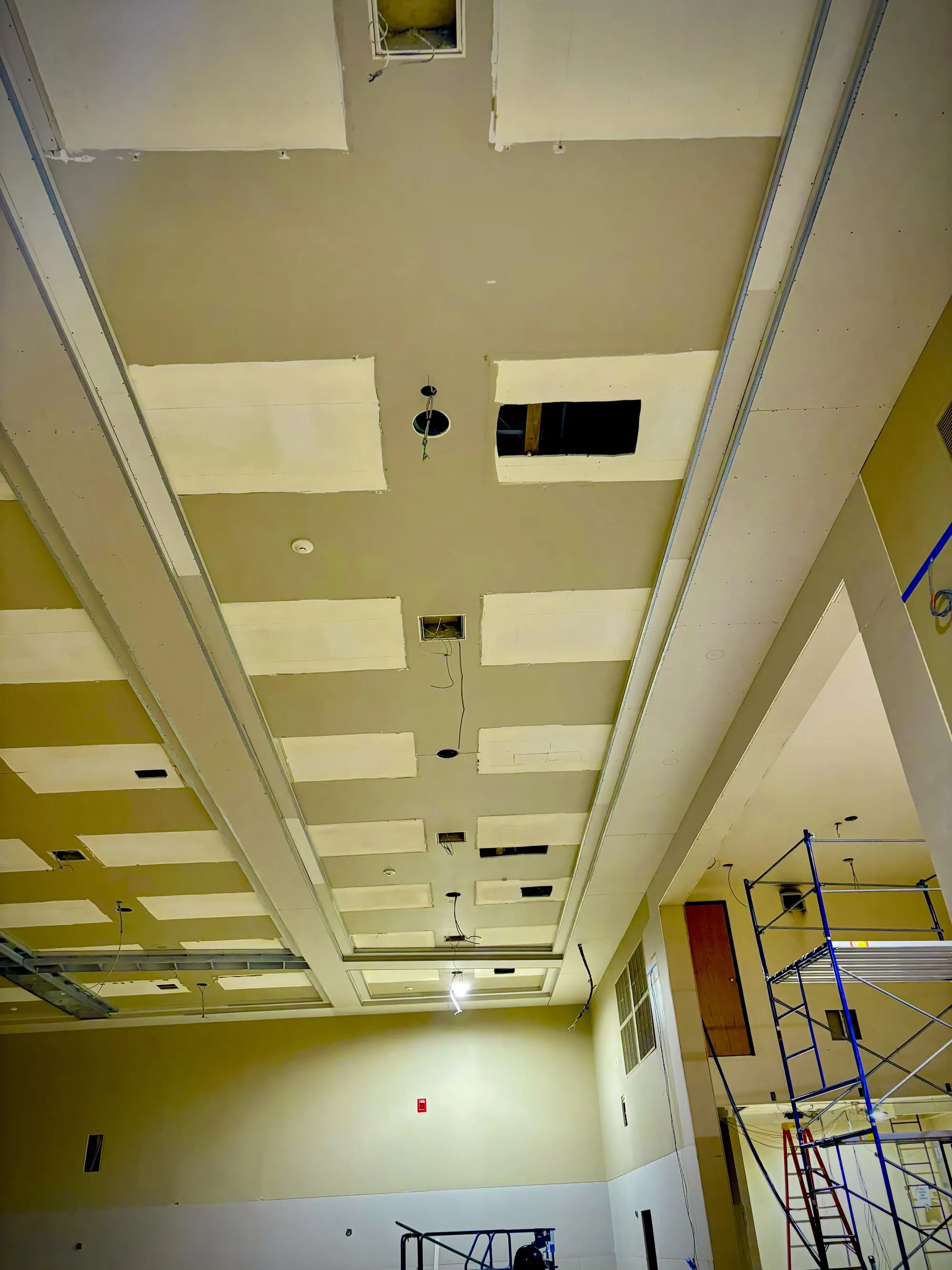 Finished drywall ceiling panels and framing in a large commercial interior